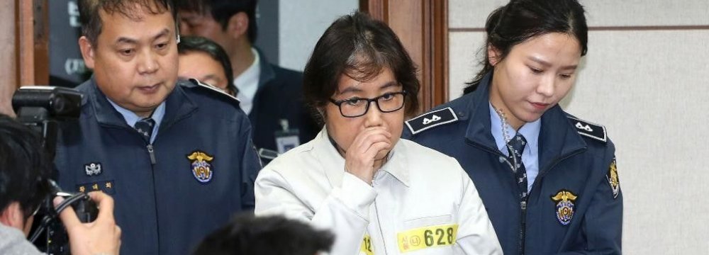 Choi Soon-sil (C) appears for the first day of her trial at the Seoul Central District Court in Seoul, South Korea, on Dec. 19.