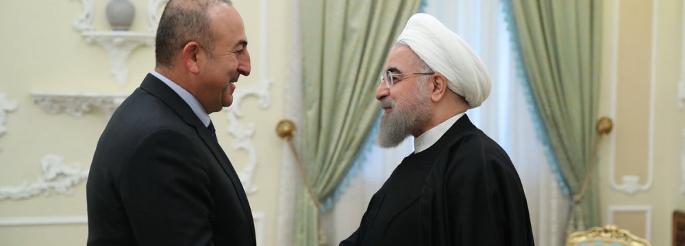 Turkish Foreign Minister Mevlut Cavusoglu (L) meets President Hassan Rouhani in Tehran on Nov. 26. 