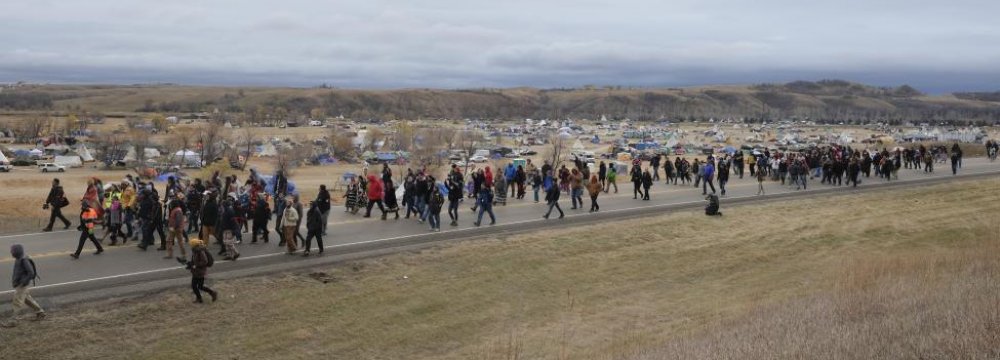 Hundreds of Native American and environmental protesters exit the Oceti Sakowin campground as they march toward a law enforcement barricade near the Dakota Access Pipeline construction site on Oct. 29.