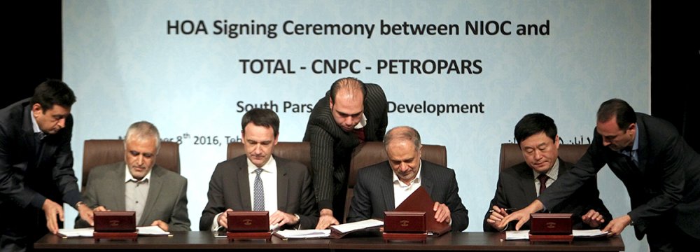 Officials from the NIOC, France's Total and China's CNPC sign a preliminary agreement to develop South Pars Phase 11 on Tuesday, Nov. 8.