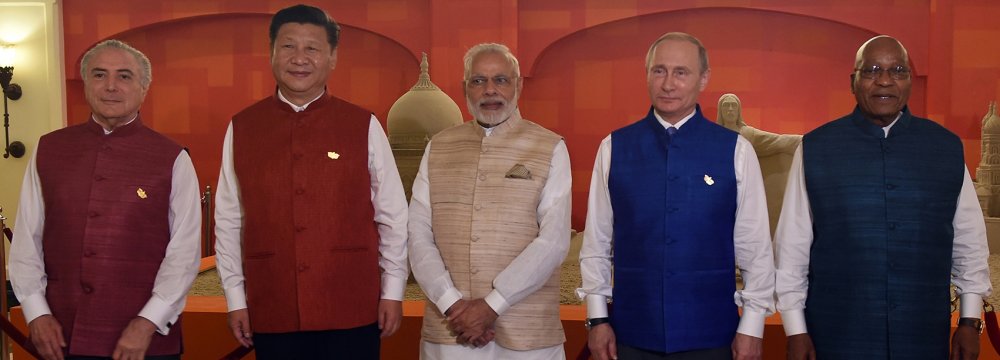 (From Left) President Michel Temer, President Xi Jingping, Prime Minister Narendra Modi, President Vladimir Putin and President Jacob Zuma pose in front  of sand art representing national monuments from BRICS member countries in Goa on October 15.