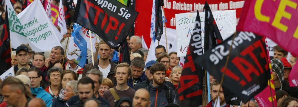 Activists rally for a demonstration against the massive transatlantic trade deals CETA and TTIP in Berlin.