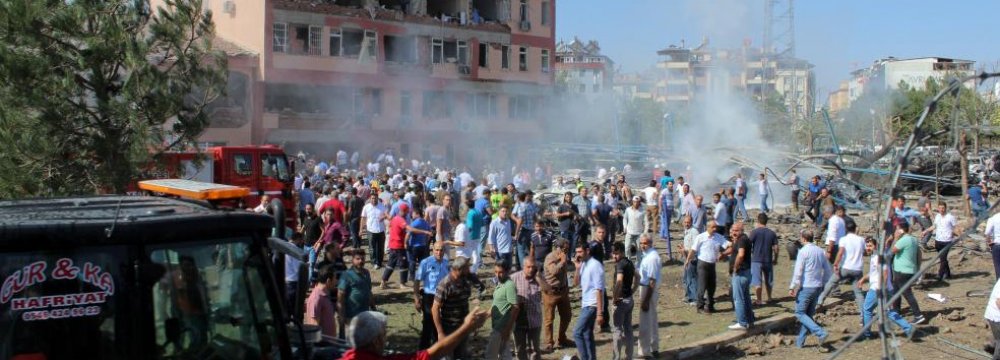 People rush to the blast scene after a car bomb attack on a police station in the eastern city of Elazig, Turkey, on Aug. 18.