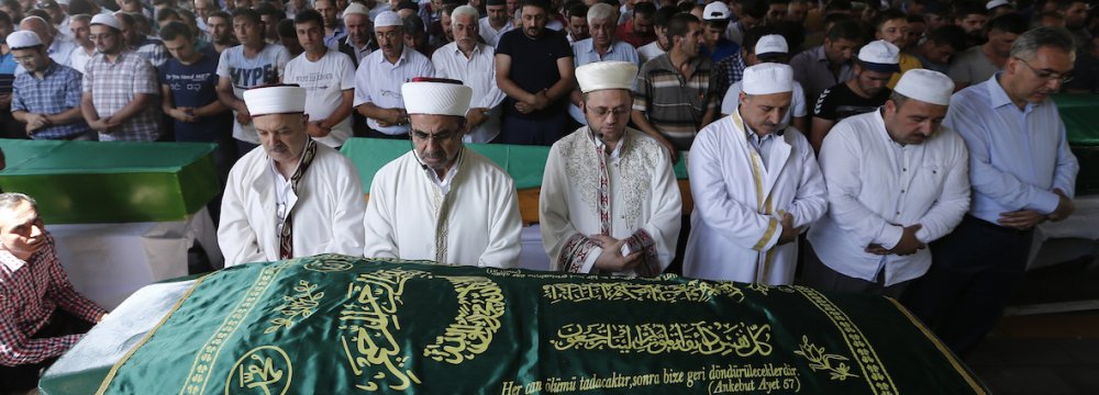 People attend the funeral of a victim killed in the bomb attack in Gaziantep, Turkey, on August 21.