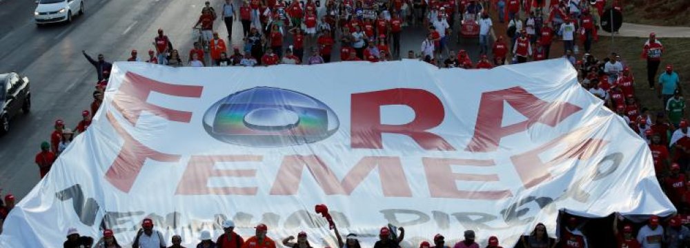 Supporters of Brazil’s suspended President Dilma Rousseff, show a banner that reads ‘Out Temer’ in reference to interim President Michel Temer during the final session of debate and voting on Rousseff’s impeachment trial in Brasilia, Brazil, August 29.