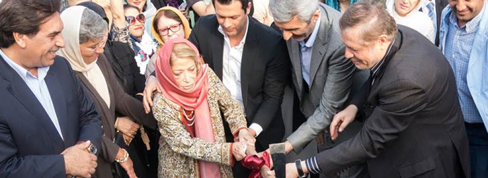 Iran Darroudi holding the pick to break the ground for the construction of her museum at a site in Yousefabad neighborhood in Tehran, September 1.