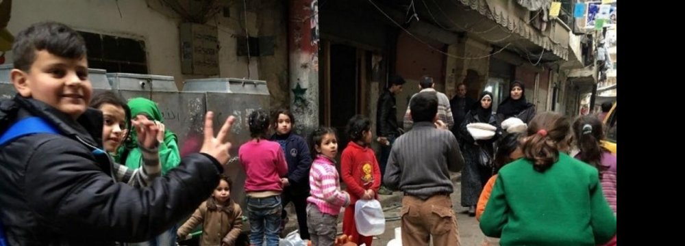 Children with cans line up for water in Nubel, north of Aleppo. (File Photo)