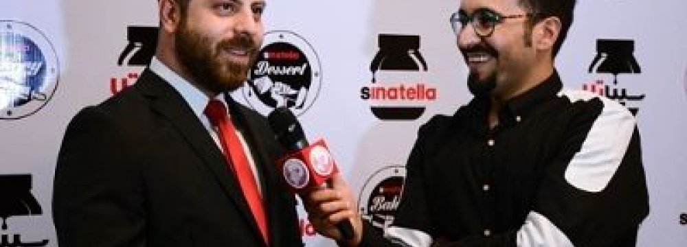 Sinatella CEO Sina Mohammadi speaks to a journalist at the first anniversary of Sinatella on Sept. 16.