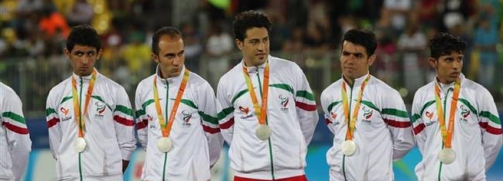 Members of the Iranian men’s national football 7-a-side team with their silver medals.