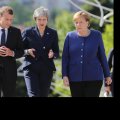 French President Emmanuel Macron (L), British Prime Minister Theresa May (C) and German Chancellor Angela Merkel walk during the EU-Western Balkans Summit in Sofia, Bulgaria on Thursday.