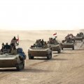 Iraqi forces and members of the Hashed al-Shaabi advance towards the city of al-Qaim, in western Anbar province, as they fight against remnant pockets of IS.