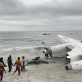 People pull the wreckage of crashed cargo plane on Oct. 14.