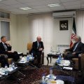 Kamal Kharrazi (R) talks with UK Junior Foreign Minister Alistair Burt in Tehran on Sunday.