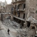 A man walks past destroyed buildings in Aleppo, Syria, in May 2016.