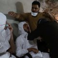 A man breathes through an oxygen mask as another one receives treatment, after what rescue workers described as a gas attack in the town of Khan Sheikhoun in rebel-held Idlib, Syria April 4.