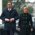 Croatia’s President Kolinda Grabar Kitarovic (R) and Serbia’s President Aleksandar Vucic walk in Zagreb on February 12.