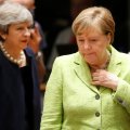 British Prime Minister Theresa May (L) and German Chancellor Angela Merkel attend the EU summit in Brussels, Belgium, on June 22.