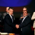 Colombia’s President Juan Manuel Santos and Marxist FARC rebel leader Rodrigo Londono, known as Timochenko, shake hands after signing a peace accord in Bogota, Colombia November 24, 2016.