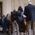 People stand in a queue to cast their ballots in Italy’s municipal elections on June 11, 2017. 