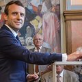French President Emmanuel Macron (L) casts his ballot in the first round of the two-stage legislative elections, in Le Touquet, northern France, on June 11.