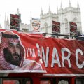 Demonstrators wave placards from an open top bus during a protest against the visit by Saudi Crown Prince  Mohammad bin Salman in central London on March 6.