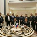 Iranian and Russian Officials attend the signing ceremony for two oil deals in Moscow on Oct. 4.