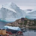 Huge Iceberg Drifts Close to Greenland Village 