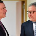 ECB President Mario Draghi (L) speaks to Managing Director of ESM Klaus Regling during a meeting of the eurogroup at the EU Council building  in Brussels on Monday. 