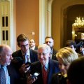 Mitch McConnell (C) walks to the senate chamber after  a conference with fellow Republicans before the vote.