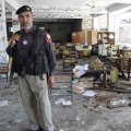 A Pakistani police officer inspects the scene of a previous terror attack.