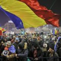 A man waves the Romanian flag during one of the protests.