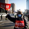 A protester, whose sign reads “Impeachment”, attends a rally in Seoul, South Korea, on Feb. 25.