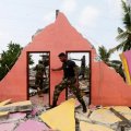 A member of the military inspects a damaged house  in Colombo, Sri Lanka, on April 15.
