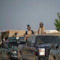 Afghan security personnel arrive at the site of the ongoing attack on the army compound in Dihdadi District of Balkh Province on April 21.