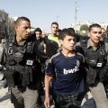 Israeli soldiers arrest a young Palestinian boy. (File Photo)