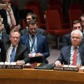 New Zealand and Russia’s UN ambassadors raise their hands during a meeting.