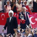 Turkey’s President Recep Tayyip Erdogan (R) accompanied by his wife Emine throws flowers to his supporters as he arrives to deliver a speech at his ruling Justice and Development Party congress in Ankara, Turkey, on August 18.