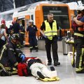 An injured passenger is attended to on the platform of a train station in Barcelona, Spain, July 28.