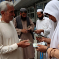 Afghan moneychangers gather to deal with foreign currency at a money market in Herat Province, Afghanistan, on June 3. 