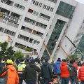 Support girders help prop up a building that came off its foundation, the morning after a 6.4 magnitude quake hit the eastern Taiwanese city of Hualien.